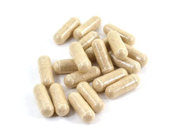 Pillole capsula di droga con farmaci beige in pila — Foto Stock