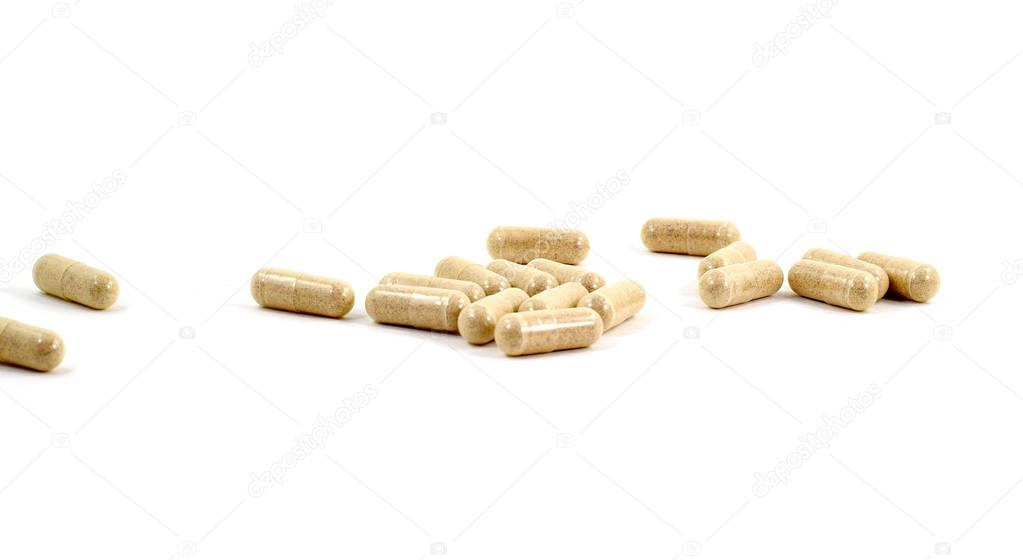 Drug capsule pills with beige medication in pile