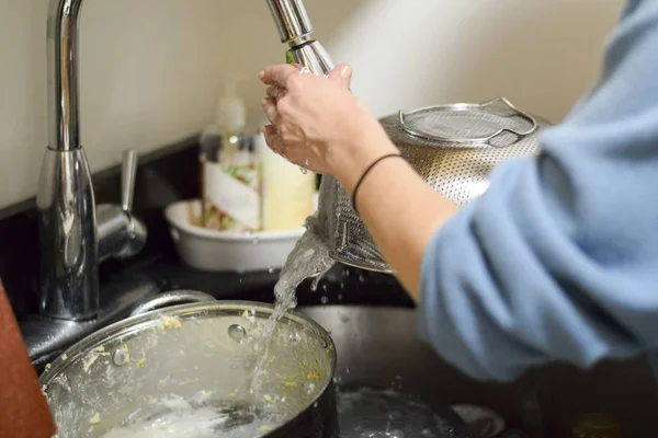 Closeup on woman's hands washing dirty dishes — Stock Photo, Image