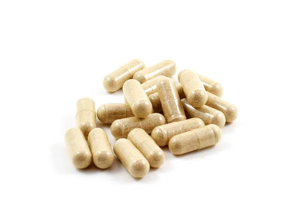 Capsules de médicaments avec médicaments beiges en pile — Photo