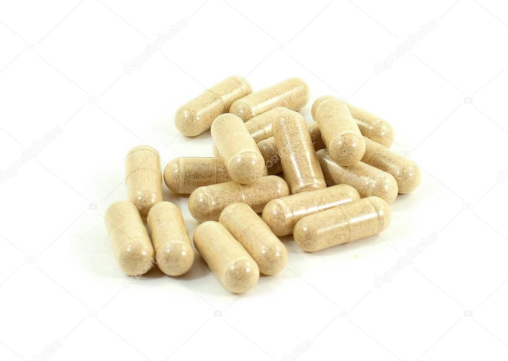 Drug capsule pills with beige medication in pile