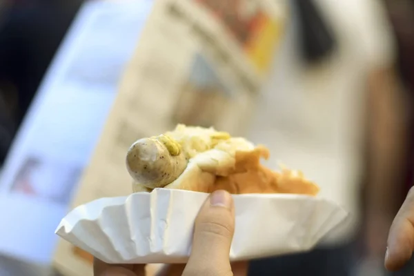 Man holding German bratwurst sausage