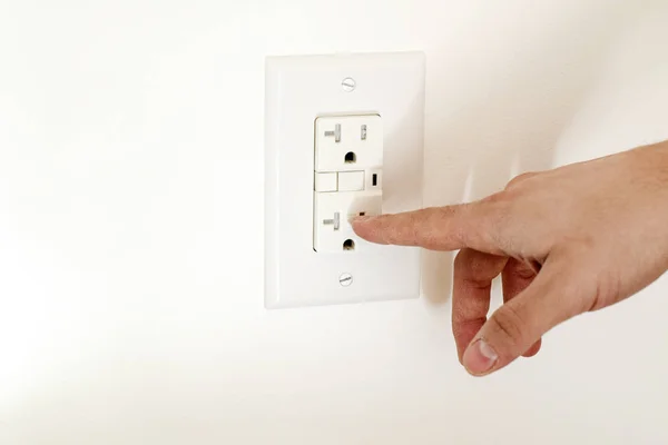 Finger dangerously close to electrical socket