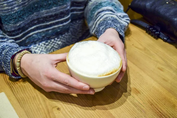 Woman holding frothy cappuccino — Stock Photo, Image