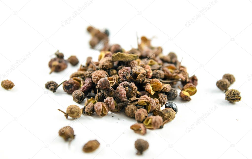 Sichuan or szechuan peppercorns isolated on white background.  They numb the mouth when eaten.