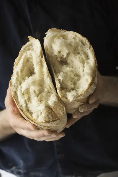 Baker holding a loaf of bread. — Stock Photo, Image