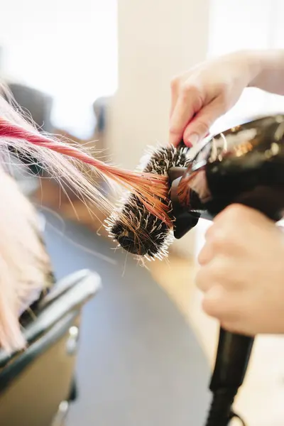 Hair stylist blowdrying hair — Stock Photo, Image