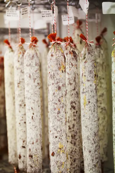 Chorizo sausages hanging from hooks — Stock Photo, Image