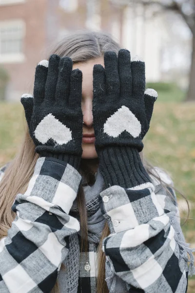 Young Woman Hiding Face Hands Woolly Gloves Heart Shaped Design — Stock Photo, Image