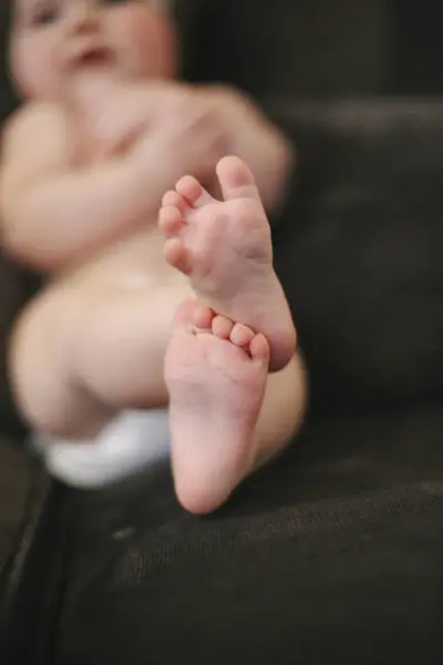 Nahaufnahme Von Füßen Eines Babys Das Windel Auf Dem Sofa — Stockfoto