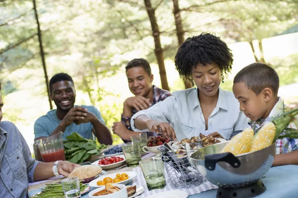 Adults Children Sitting Picnic Table Food Outdoors — Stock Photo, Image