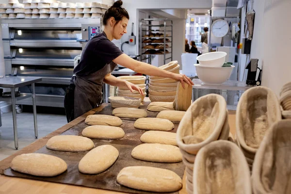 Woman Wearing Apron Standing Artisan Bakery Shaping Sourdough Loaves Baking — Stock Photo, Image