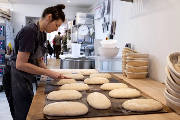 Frau Mit Schürze Steht Handwerklicher Bäckerei Und Formt Sauerteigbrote Zum — Stockfoto