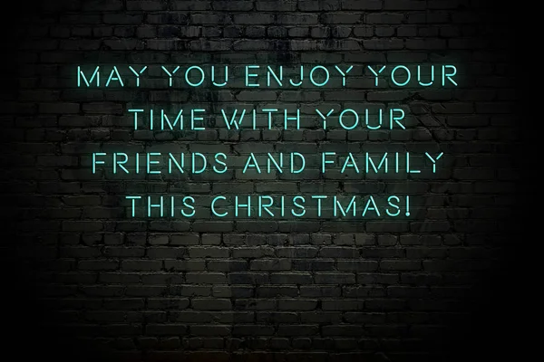 Neon inscription of christmas and new year greetings on brick wall — ストック写真