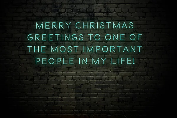 Neon inscription of christmas and new year greetings on brick wall — ストック写真