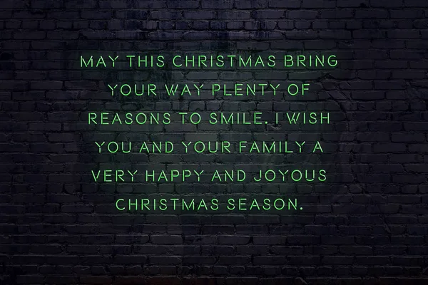 Neon inscription of christmas and new year greetings on brick wall — ストック写真