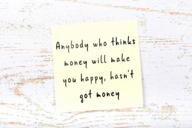 Ahşap duvardaki sarı yapışkan notta bilgece bir alıntı var.