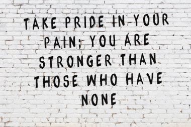 Bilgece alıntıların yazılı olduğu siyah boyanmış beyaz tuğla duvar