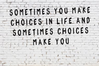 Bilgece alıntıların yazılı olduğu siyah boyanmış beyaz tuğla duvar