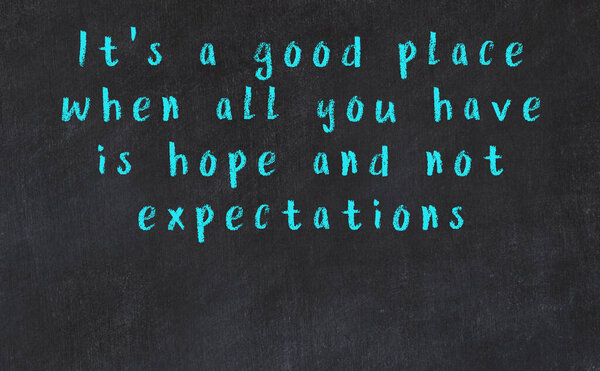 Black chalkboard with wise inscription on it