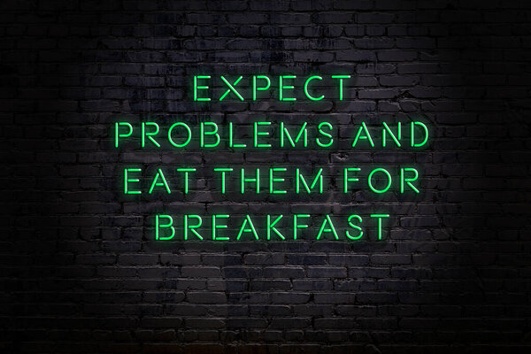 Smart and motivational quotation. Neon sign on brick wall