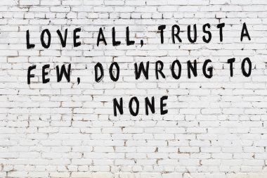 Bilgece alıntıların yazılı olduğu siyah boyanmış beyaz tuğla duvar