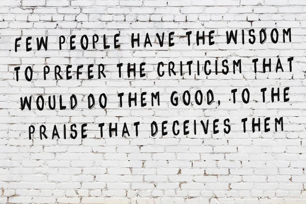 White brick wall with painted black inscription of wise quote — Stock Photo, Image