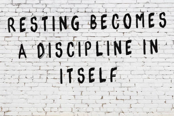 Bilgece alıntıların yazılı olduğu siyah boyanmış beyaz tuğla duvar