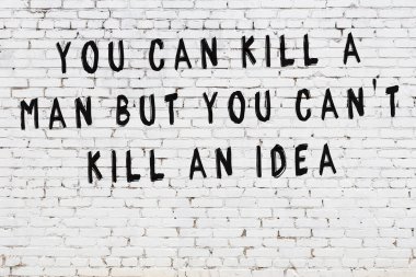 Bilgece alıntıların yazılı olduğu siyah boyanmış beyaz tuğla duvar