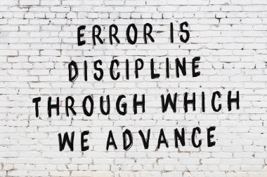 Beyaz tuğla duvar arkaplanına siyah düşünceli bir yazı.