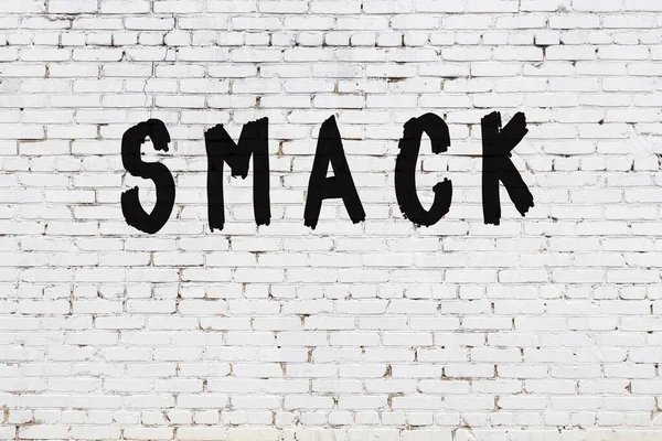Word smack painted on white brick wall — Stock Photo, Image