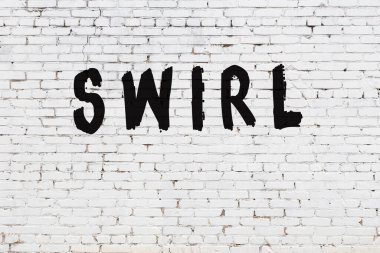 Üzerinde siyah boya yazıları olan beyaz bir duvar.