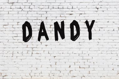 Beyaz tuğla duvarda züppe kelimesi yazılı.