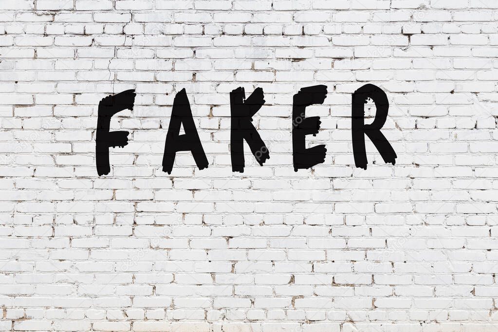 Word faker painted on white brick wall
