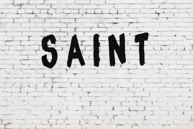 Sözcük azizi beyaz tuğla duvara boyanmış.