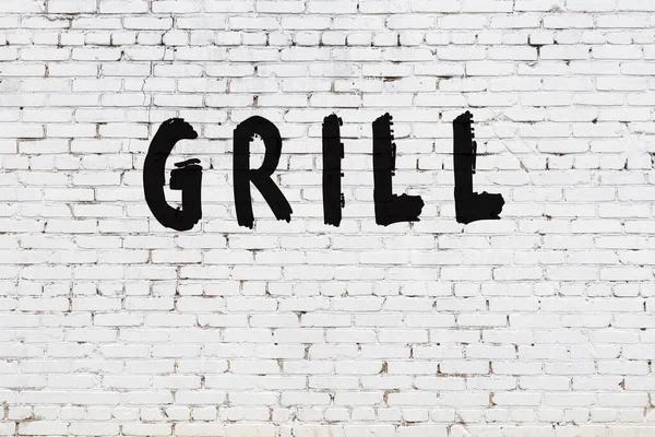 Word grill painted on white brick wall — Stock Photo, Image