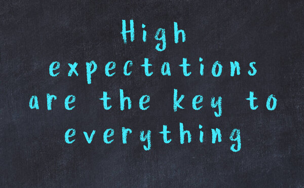 Chalk wise inscription on black chalkboard