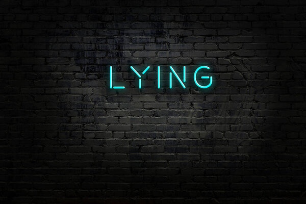 Night view of neon sign on brick wall