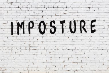 Üzerinde siyah boya yazıtları olan beyaz duvar.