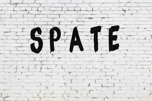 Espada de palavras pintada na parede de tijolo branco — Fotografia de Stock