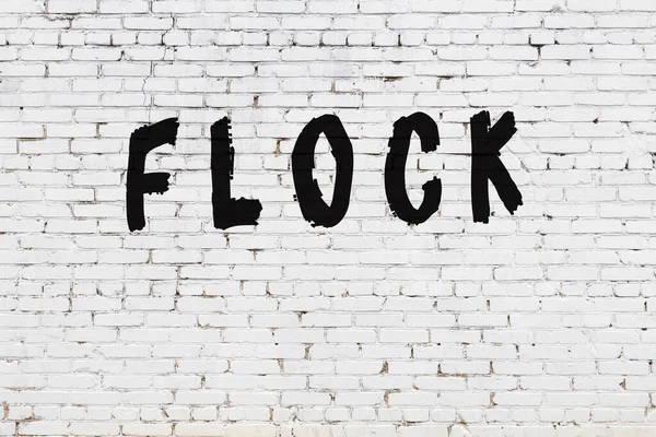 Word flock målad på vit tegelvägg — Stockfoto