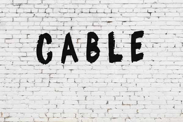 Word cable painted on white brick wall — Stock Photo, Image