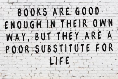 Bilgece alıntıların yazılı olduğu siyah boyanmış beyaz tuğla duvar