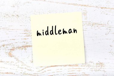 Tahta duvardaki sarı yapışkan notta el yazısıyla yazılmış bir aracı var.