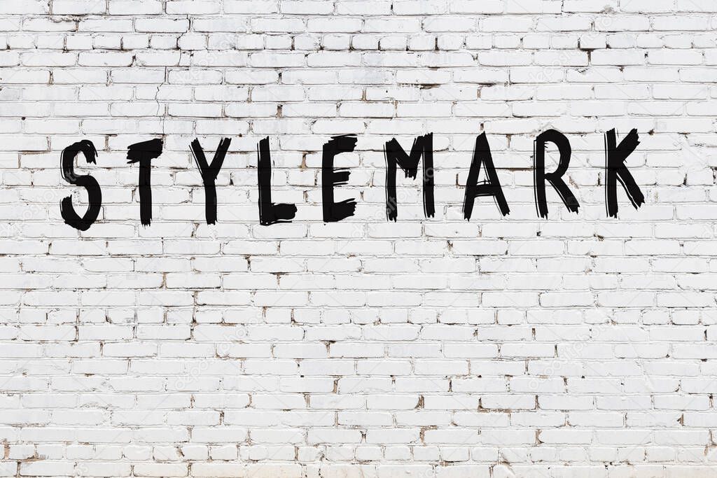 Word stylemark painted on white brick wall