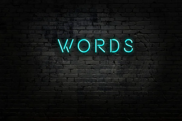 Neon tecken med inskription ord mot tegelvägg — Stockfoto