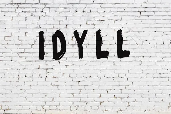Η λέξη idyll ζωγραφισμένο σε λευκό τοίχο τούβλο — Φωτογραφία Αρχείου
