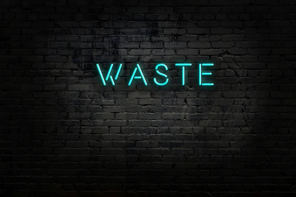 Neonový nápis s nápisem odpad proti cihlové zdi — Stock fotografie