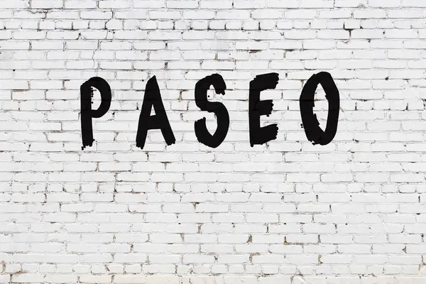 Word paseo painted on white brick wall — Stock Photo, Image