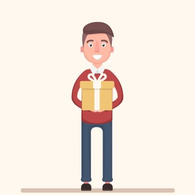 Neşeli çocuk büyük bir hediye elinde tutar.